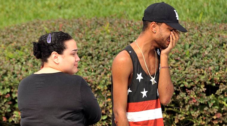 Friends and family members embrace outside the Orlando Police Headquarters during the investigation of a shooting at the Pulse nightclub, where people were killed by a gunman, in Orlando, Florida, U.S June 12, 2016.  REUTERS/Steve Nesius